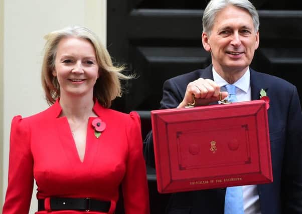 Chancellor Philip Hammond holds his red ministerial box outside 11 Downing Street, London, flanked by Treasury colleagues Liz Truss (left) and Mel Stride, before heading to the House of Commons to deliver his Budget. PRESS ASSOCIATION Photo. Picture date: Monday October 29, 2018. See PA story BUDGET Main. Photo credit should read: David Mirzoeff/PA Wire
