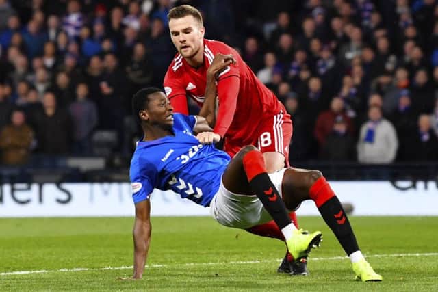 Mikey Devlin challenges Umar Sadiq during Aberdeen's 1-0 win over Rangers. Picture: SNS Group