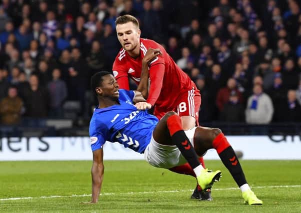 Mikey Devlin challenges Umar Sadiq during Aberdeen's 1-0 win over Rangers. Picture: SNS Group