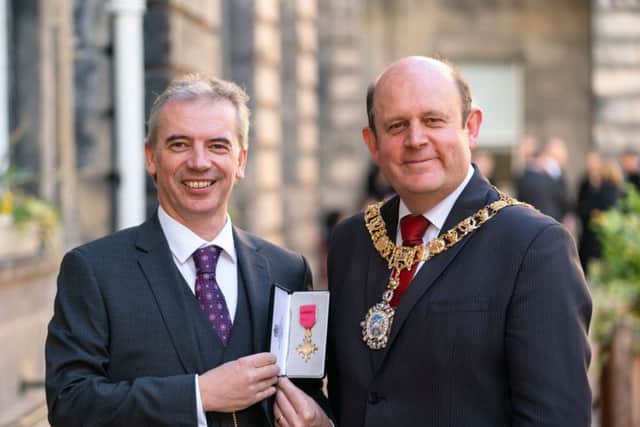 Edinburgh Napier University scientist Martin Tangney receiving his OBE from Lord-Lieutenant Frank Ross. Picture: Ashley Coombes