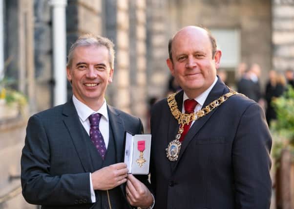 Edinburgh Napier University scientist Martin Tangney receiving his OBE from Lord-Lieutenant Frank Ross. Picture: Ashley Coombes