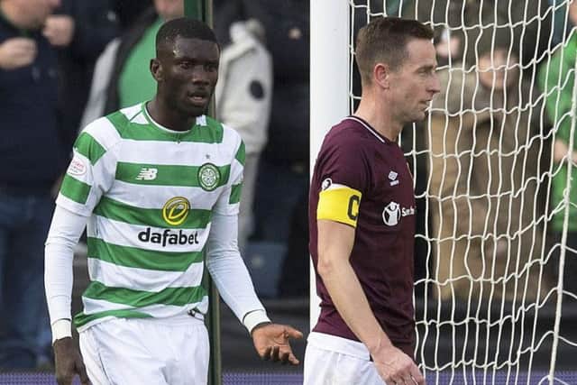 Celtic's Eboue Kouassi (L) with Hearts' Steven MacLean. Picture: SNS