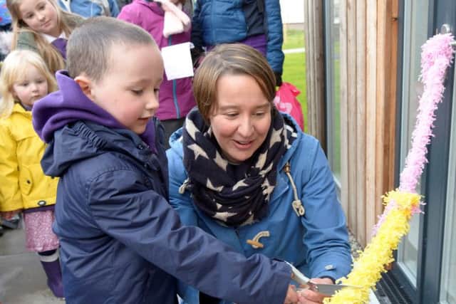 P1 pupil Fionn Togher cuts the ribbon at New Strontian School. Picture:SWNS