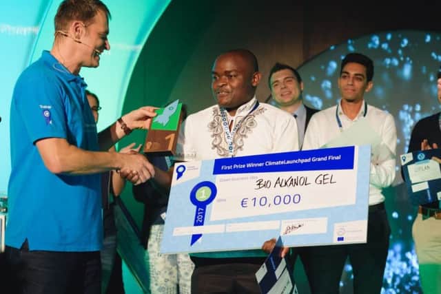 Bio-Alkanol Gel founder and chief executive Jiveri Boniface collects ClimateLaunchpad 2017's grand final prize. Picture: contributed