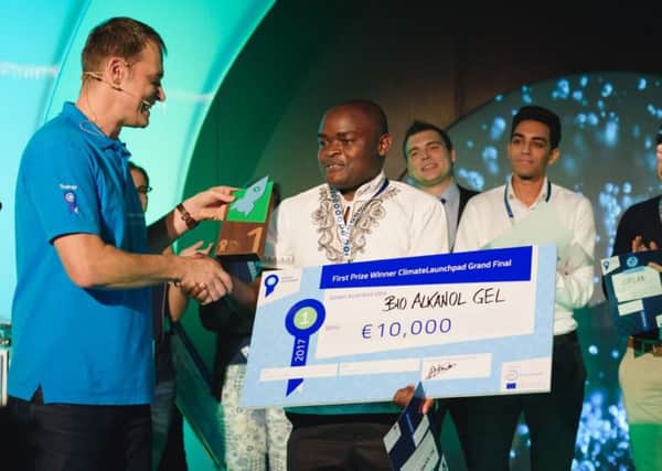 Bio-Alkanol Gel founder and chief executive Jiveri Boniface collects ClimateLaunchpad 2017's grand final prize. Picture: contributed
