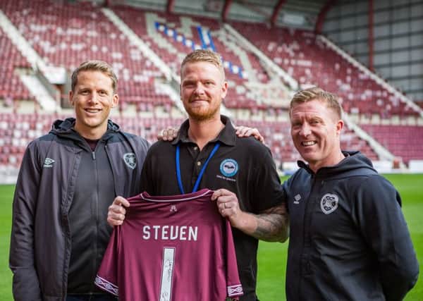 Steven Williams, Royal Scots veteran and operations manager at Lothians Veterans Centre at Tynecastle, home of his beloved Hearts Football Club, with Christophe Berra and Gary Locke.