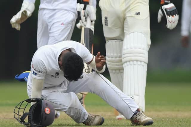 Sri Lanka fielder Pathum Nissanka falls after being hit on the helmet from a shot by England batsman Jos Buttler.  Picture: Stu Forster/Getty Images