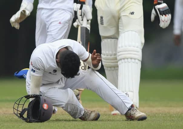 Sri Lanka fielder Pathum Nissanka falls after being hit on the helmet from a shot by England batsman Jos Buttler.  Picture: Stu Forster/Getty Images