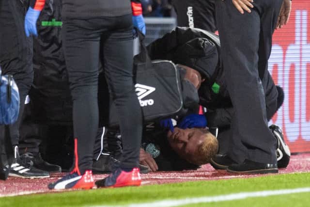 Hibs manager Neil Lennon lies on the ground after being struck by an object from the crowd. Picture: Craig Williamson/SNS