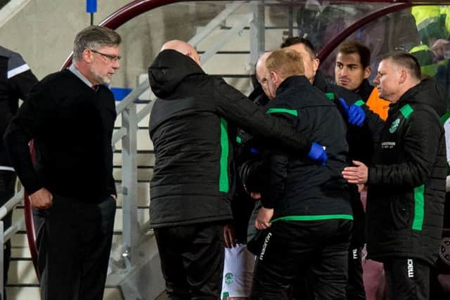 Craig Levein looks on as
Hibs manager Neil Lennon is helped to his feet after appearing to be struck by an object. Picture: Ross Parker/SNS