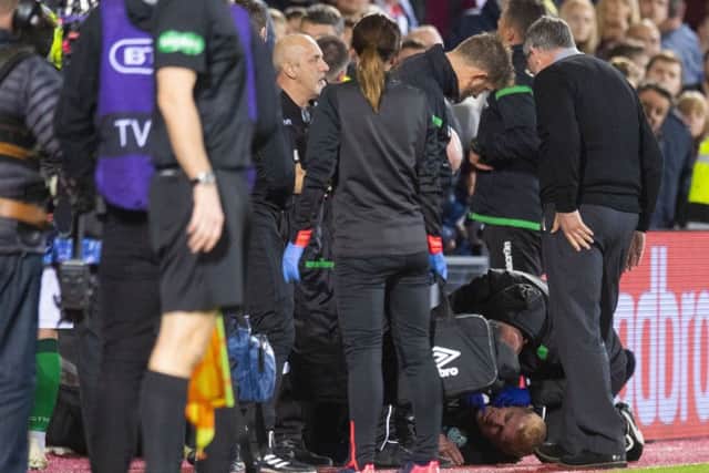 Hibernian manager Neil Lennon on the ground after appearing to be struct by an object from the crowd. Picture: SNS Group