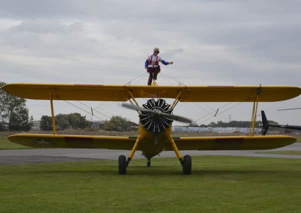 Anne Kelly takes off on her wing walk challenge from an airfield in Yorkshire