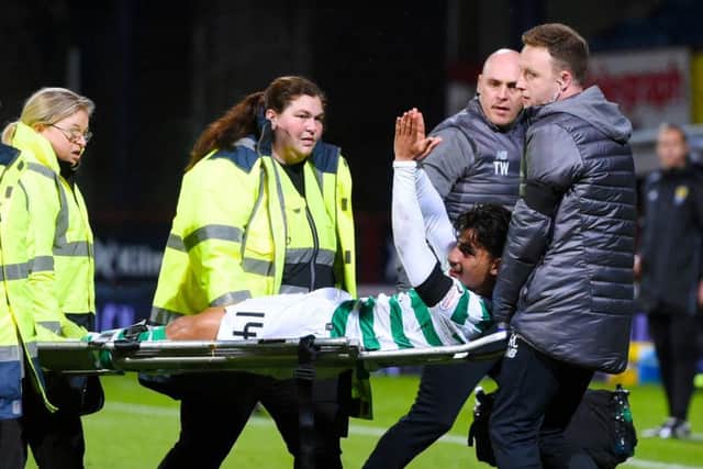 Daniel Arzani applauds the Celtic fans after being stretchered off on his debut. Picture: SNS