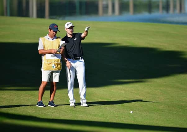 Russell Knox and his caddie weigh up a shot on his way to a 66 in the Turkish Airlines Open. Picture: Stuart Franklin/Getty Images