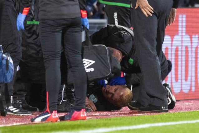 Hibs manager Neil Lennon lies on the ground after being struck by a coin at Tynecastle. Picture: Craig Williamson/SNS