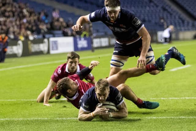 Edinburghs Tom Brown dives over to score his second try of the match against Scarlets at BT Murrayfield last night. Picture: SNS/SRU.