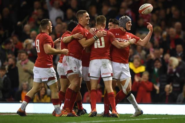 Jonathan Davies celebrates with his Welsh team-mates after scoring their third try. Picture: Getty