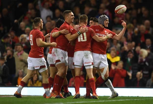 Jonathan Davies celebrates with his Welsh team-mates after scoring their third try. Picture: Getty