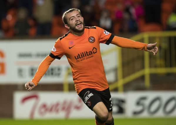 Dundee United's Paul McMullan celebrates after Queen of the South's Michael Doyle's own goal. Picture: SNS