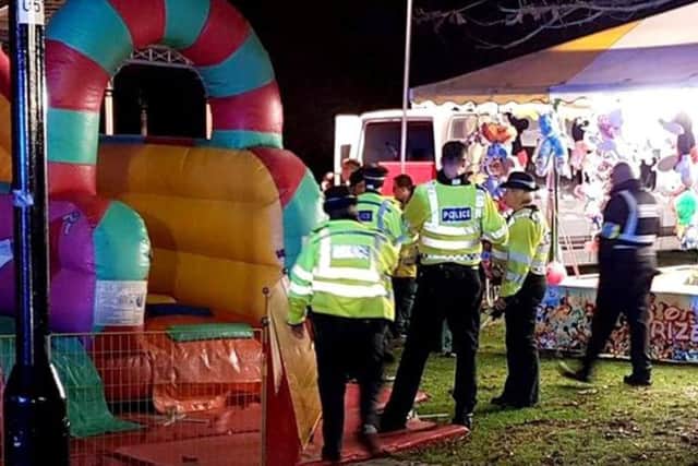 Picture from @AndyDatsonWT of emergency services at the scene where six children are being treated for "potentially serious injuries" after an inflatable slide is believed to have collapsed at a fireworks funfair in Woking Park, Surrey.