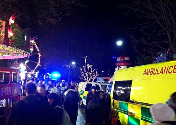 Picture from @AndyDatsonWT of emergency services at the scene where six children are being treated for "potentially serious injuries" after an inflatable slide is believed to have collapsed at a fireworks funfair in Woking Park, Surrey.