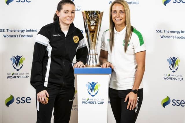 Suzanne Mulvey of Motherwell and Joelle Murray of Hibs with the new Scottish Women's Cup. Ella Sharp designed the trophy. Picture: Roddy Scott