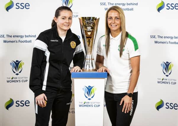 Suzanne Mulvey of Motherwell and Joelle Murray of Hibs with the new Scottish Women's Cup. Ella Sharp designed the trophy. Picture: Roddy Scott