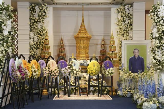 The royal urn with the remains of Vichai Srivaddhanaprabha is displayed at a Buddhist temple next to his portrait. Picture: AP