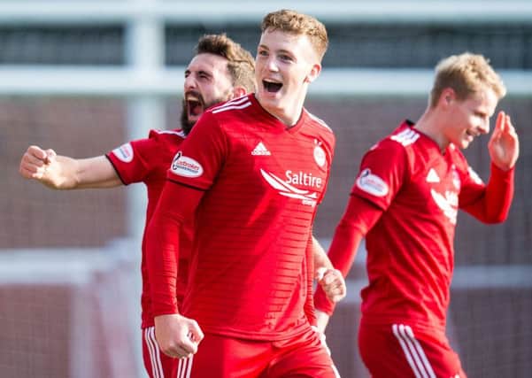 Lewis Ferguson celebrates after his free kick secured the three points for Aberdeen. Picture: SNS Group