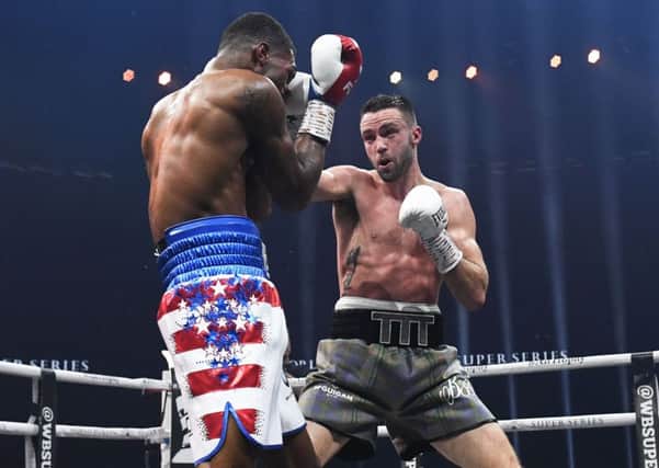 Josh Taylor lands a blow on his way to defeating Ryan Martin. Picture: SNS