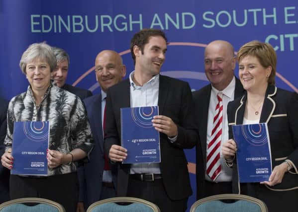 Edinburgh city region deal. Pictured at the signing ceremony: Midlothian Council Leader, Councillor Derek Milligan (second from right) with Prime Minister Theresa May, First Minister Nicola Sturgeon, City of Edinburgh Council Leader Adam McVey (centre) and other council leaders.