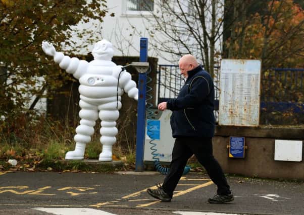 A worker walks past an air pump outside Michelin's Dundee tyre factory after the company announced plans to close the site (Picture: Andrew Milligan/PA)