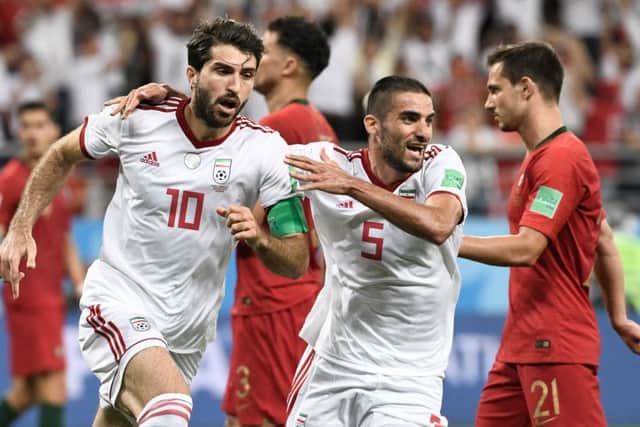 Milad Mohammadi, centre, celebrates Karim Ansari Fard's goal for Iran against Portugal at the 2018 World Cup. Picture: Getty Images