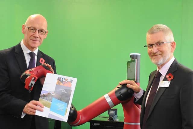 From left: John Swinney MSP, Sawyer the collaborative robot, and Ron Fraser of Construction Scotland. Picture: Whyler Photos of Stirling.