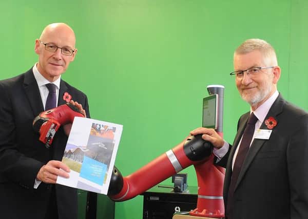 From left: John Swinney MSP, Sawyer the collaborative robot, and Ron Fraser of Construction Scotland. Picture: Whyler Photos of Stirling.