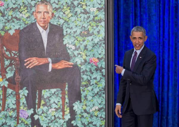 Former US President Barack Obama gestures to his portrait Ã¿at the Ã¿National Portrait Gallery in Washington DC (Picture: Saul Loeb/AFP/Getty)