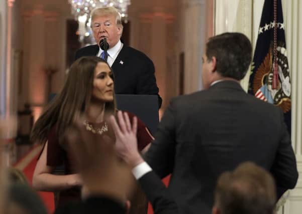 The altercation as Donald Trump looks on. (AP Photo/Evan Vucci)