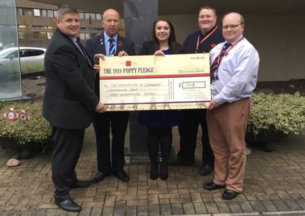 Conservative councillors at North Lanarkshire Council hand over a cheque to Poppyscotland's head of fundraising Gordon Michie (left)