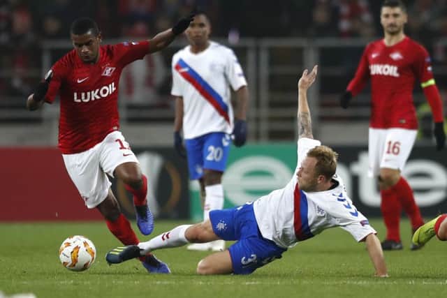 Scott Arfield challenges Spartak's Fernando at the Otkritie Arena. Picture: AP/Pavel Golovkin