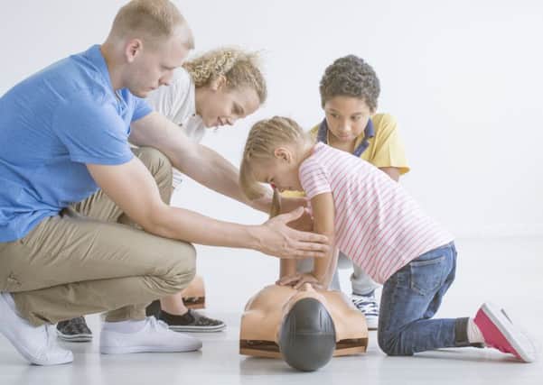 A paramedic teaches a group of children CPR, which Cayden Mcauley has gone on to learn as his mother suffers from chronic heart failure and is waiting for a new heart. Picture: Getty