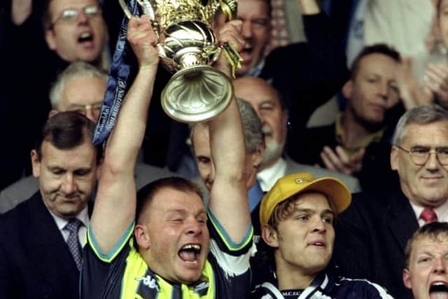 Manchester City captain Andy Morrison lifts the play-off trophy after the win over Gillingham at Wembley in 1999. Picture: Gary M Prior/Allsport