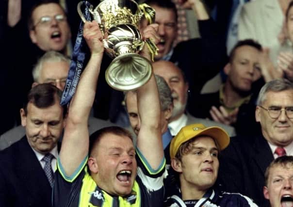 Manchester City captain Andy Morrison lifts the play-off trophy after the win over Gillingham at Wembley in 1999. Picture: Gary M Prior/Allsport