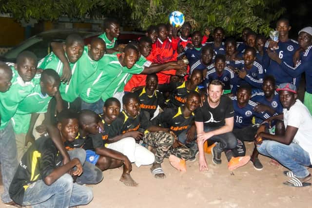 Andrew Jenkin, a founding trustee of Africa on the Ball, with some of the people the charity has helped.
