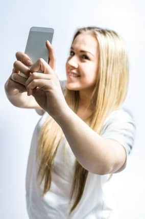 Selfies have been linked to narcissism.