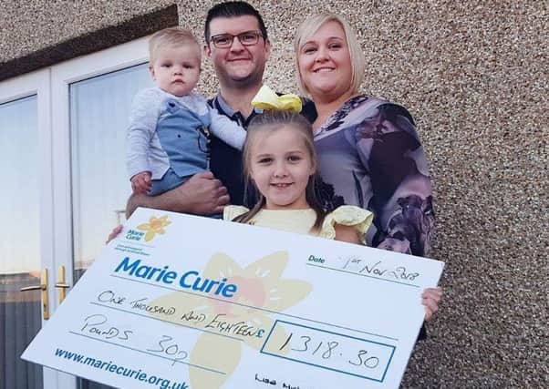 Lisa, with her husband David, daughter Maddison and son Mason with the bumper cheque for Marie Curie