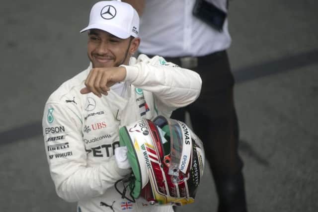 Lewis Hamilton celebrates after taking pole position for the Brazil Grand Prix. Pic: Mauro Pimentel / AFP/Getty