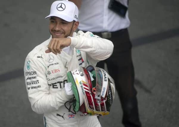 Lewis Hamilton celebrates after taking pole position for the Brazil Grand Prix. Pic: Mauro Pimentel / AFP/Getty