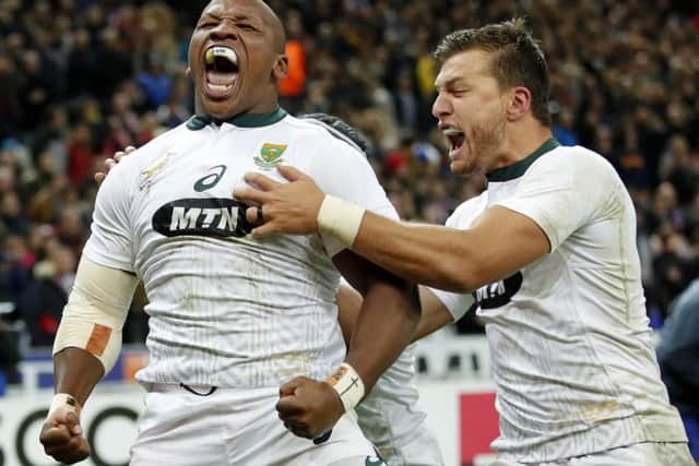 South Africa's Bongi Mbonambi, left, is congratulated by teammate Handre Pollard as he celebrates his match winning try against France. Picture: Christophe Ena/AP