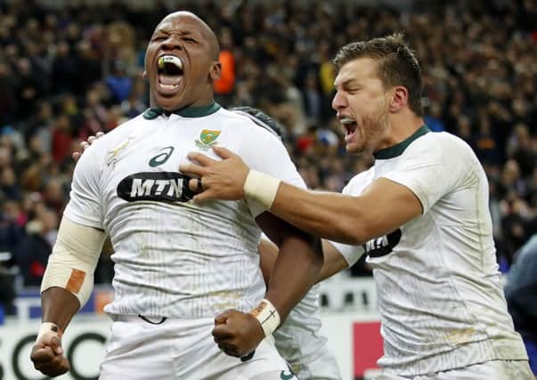 South Africa's Bongi Mbonambi, left, is congratulated by teammate Handre Pollard as he celebrates his match winning try against France. Picture: Christophe Ena/AP