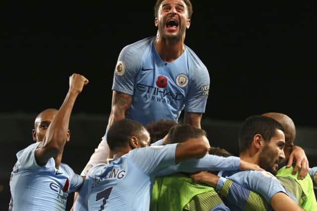 Manchester City's Kyle Walker, top, celebrates after Ilkay Gundogan scored his side's third goal in the 3-1 win over Manchester United. Picture: Dave Thompson/AP